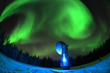 Aurora borealis over a satellite ground antenna in Finland